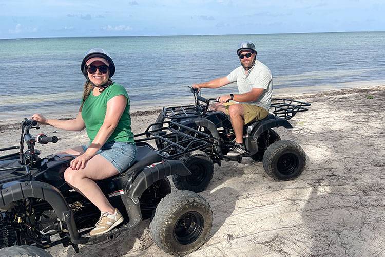 couple on atv ride on beach