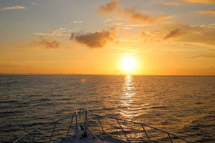 front of boat on sunset cruise in North Sound of Grand Cayman