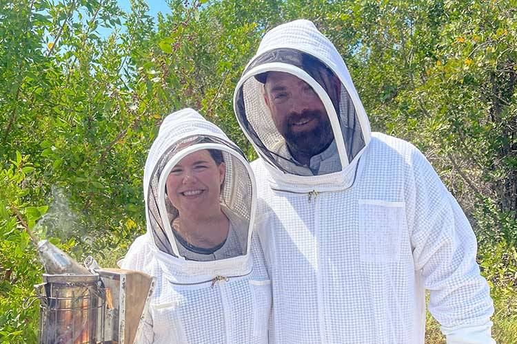 couple in beesuits with smoker