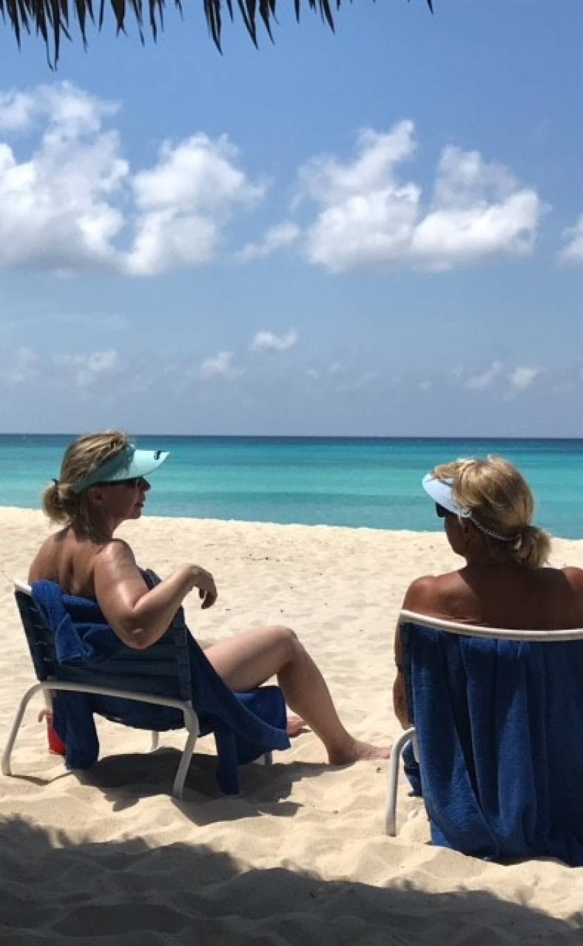 women on beach chatting