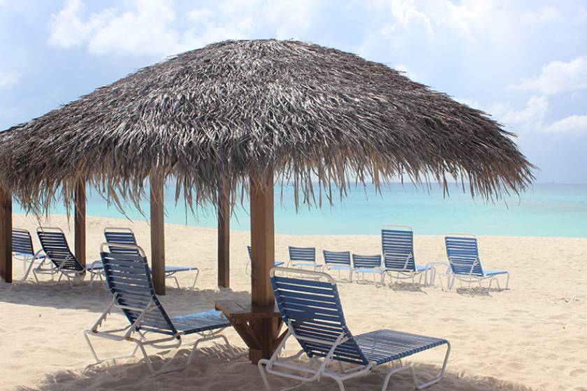 huts and lounge chairs on sandy beach