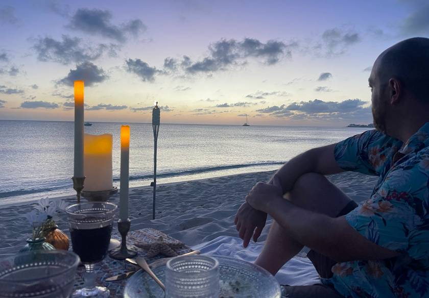 handsome man looking out at dusk beachfront