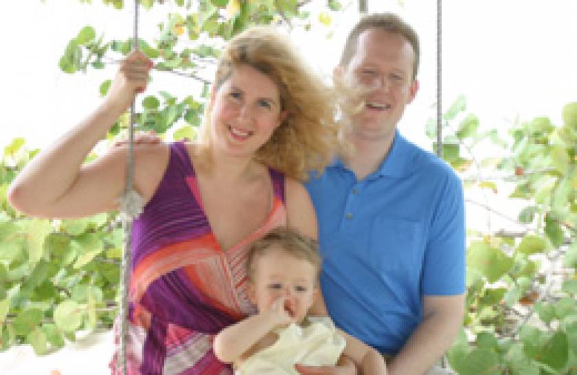 family on beach swing