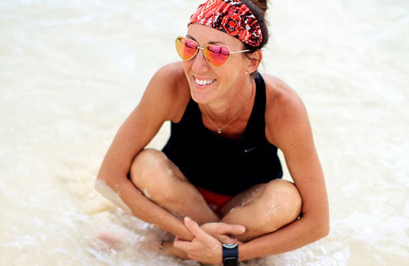 woman in heart shaped sunglasses at beach