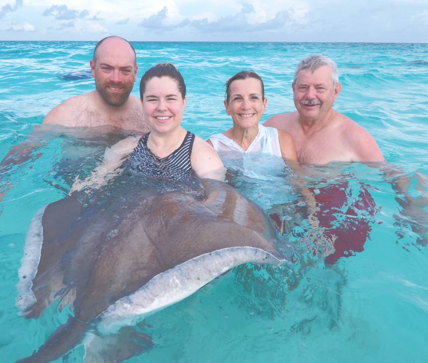 group huddle around a huge stringray