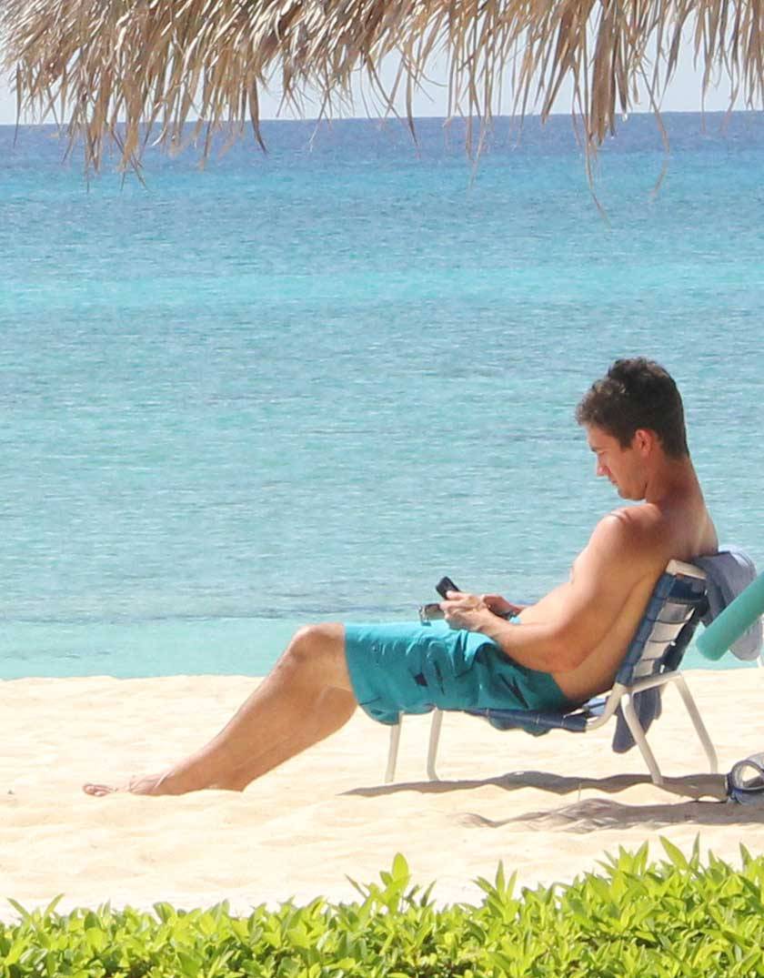 man in lounger using a phone