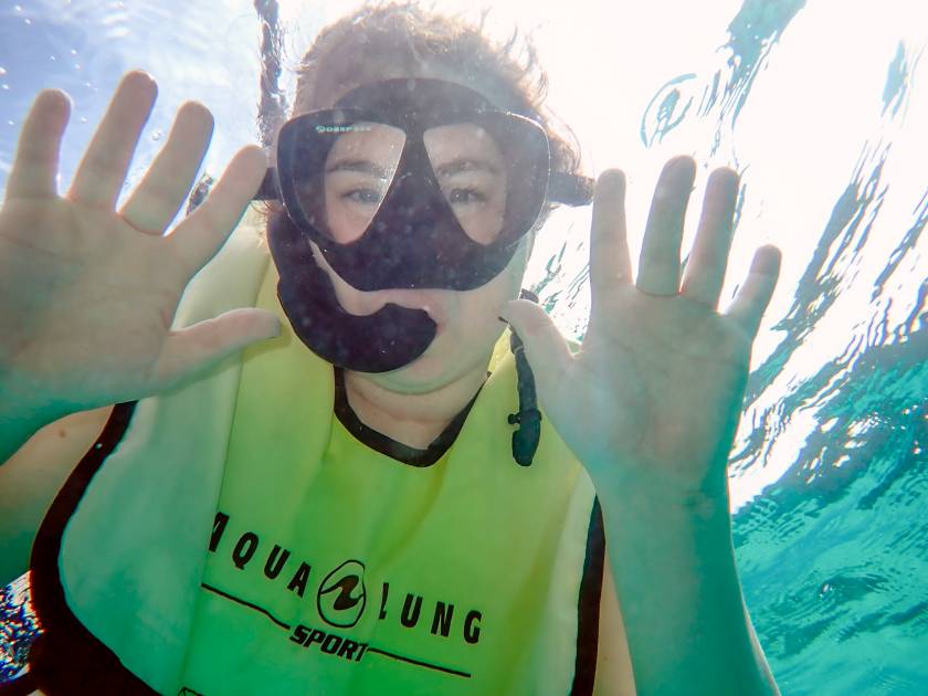 snorkeler making silly face underwater