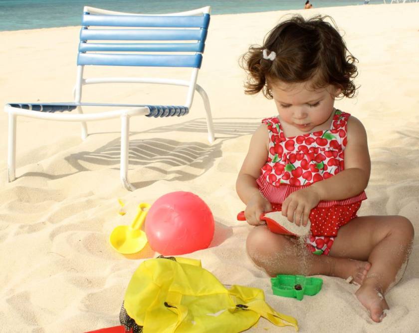 toddler playing with toys in sand